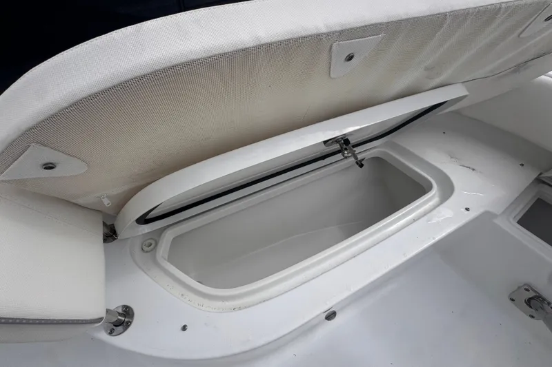 Slide: The Image of Open storage compartment on 2024 Sea Hunt Escape 25 boat, showcasing interior space. - 50