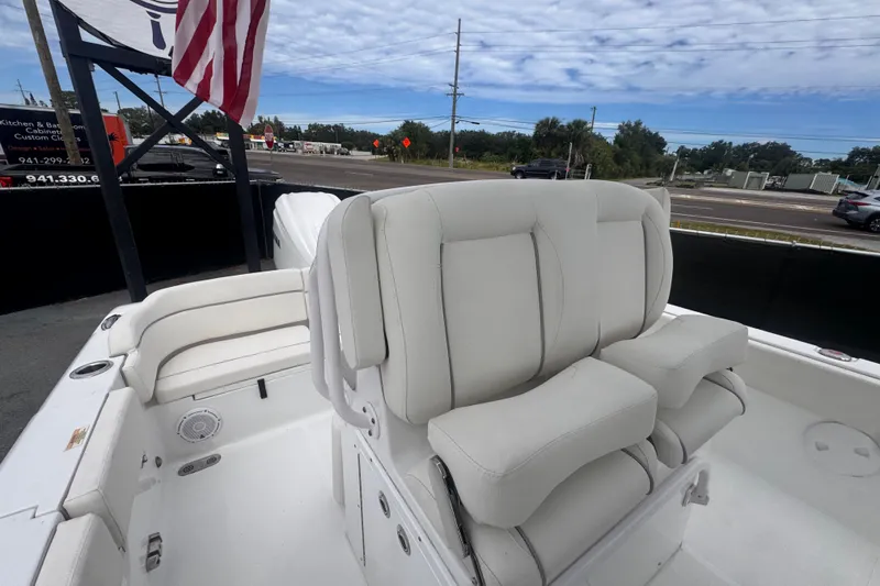 Slide: The Image of 2024 Sea Hunt Escape 25 boat interior with white seating and American flag. - 63