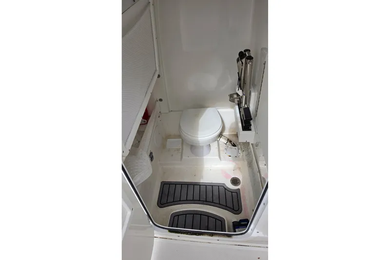 Slide: The Image of 2024 Sea Hunt Escape 25 boat bathroom interior with toilet and storage. - 12