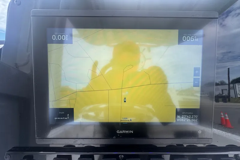 Slide: The Image of Garmin GPS display on 2024 Sea Hunt Escape 25 boat, showing navigation map and coordinates. - 26