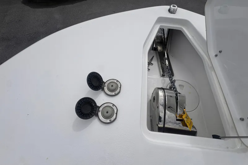 Slide: The Image of 2024 Sea Hunt Escape 25 boat deck with anchor storage and fuel caps. - 55