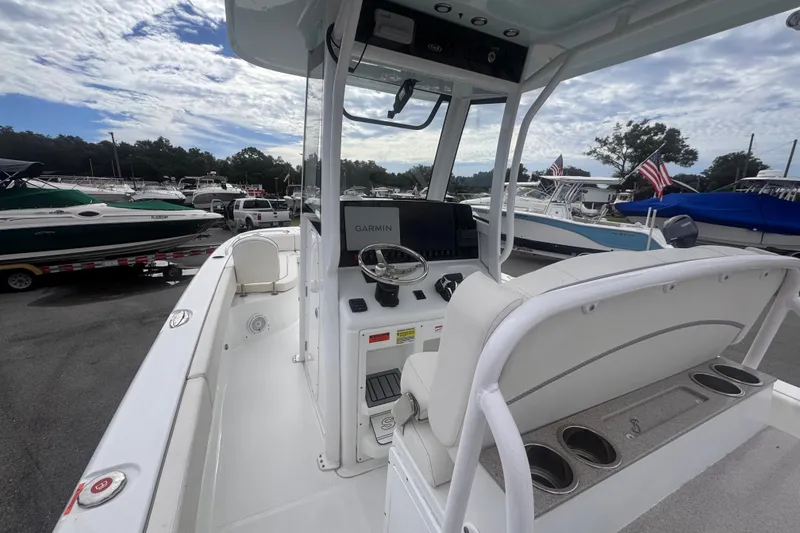 Slide: The Image of 2024 Sea Hunt Escape 25 boat interior with Garmin navigation system, docked at marina. - 21