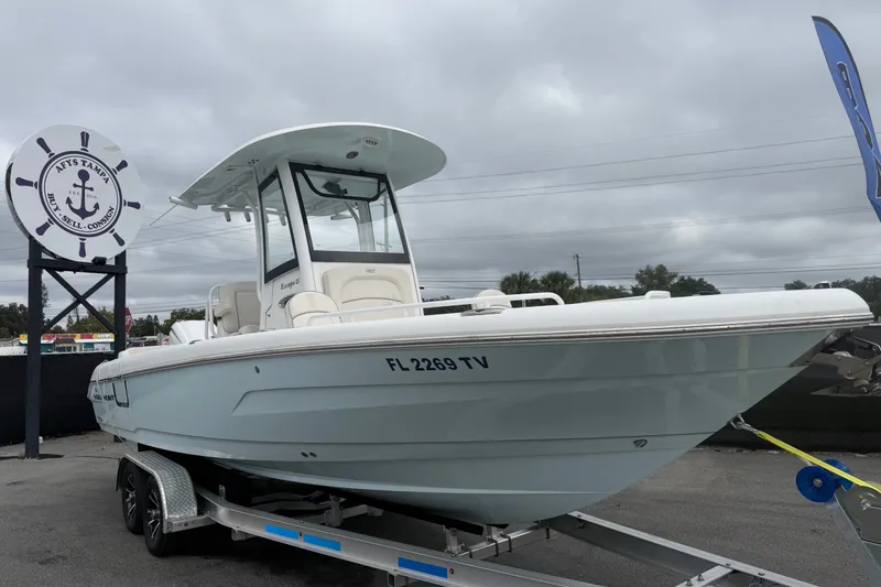 The Image of 2024 Sea Hunt Escape 25 boat on trailer, displayed outdoors under cloudy sky. - 0
