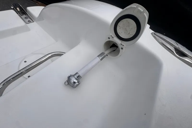 Slide: The Image of 2024 Sea Hunt Escape 25 boat deck with a fuel filler cap and rod holder. - 70