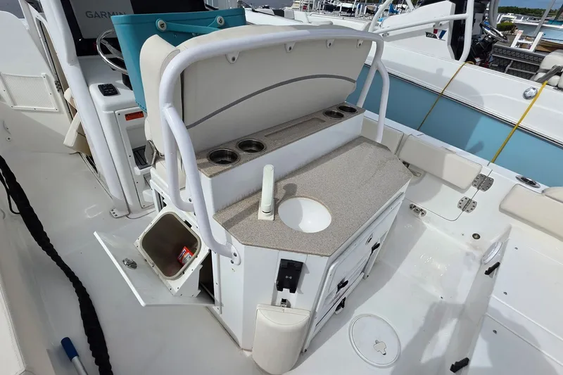 Slide: The Image of 2024 Sea Hunt Escape 25 boat interior with sink, storage, and cup holders. - 6