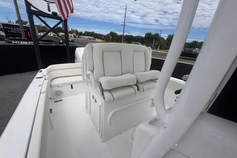 Slide: The Image of 2024 Sea Hunt Escape 25 boat interior with white seating and helm station. - 62