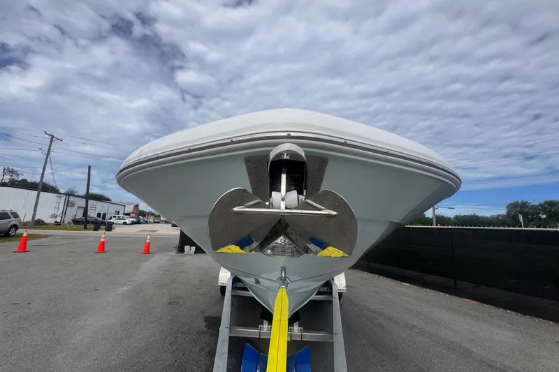 Slide: The Image of 2024 Sea Hunt Escape 25 boat on trailer, showcasing bow and anchor under cloudy sky. - 13