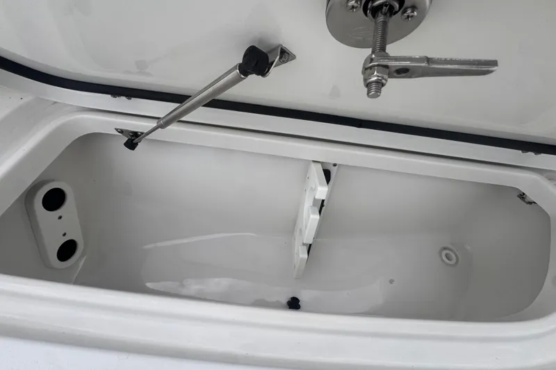 Slide: The Image of Open storage compartment in 2024 Sea Hunt Escape 25 boat, showcasing interior details. - 57