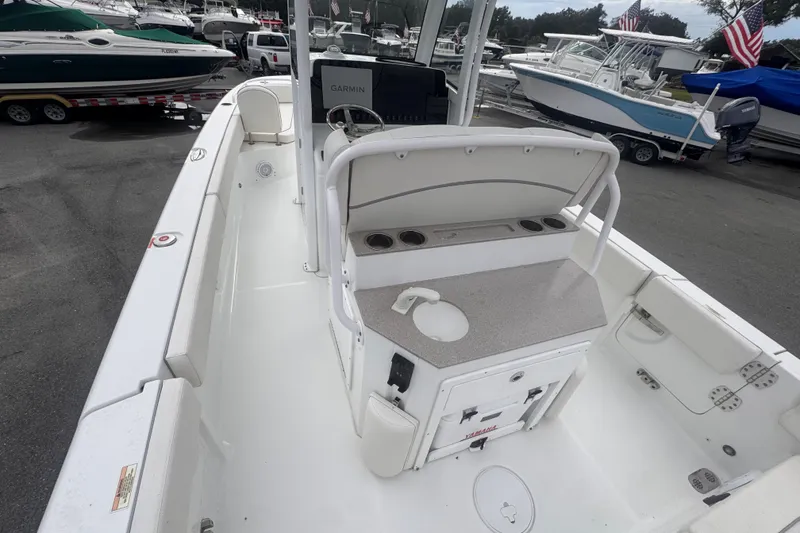 Slide: The Image of 2024 Sea Hunt Escape 25 boat interior with helm, sink, and storage compartments. - 18