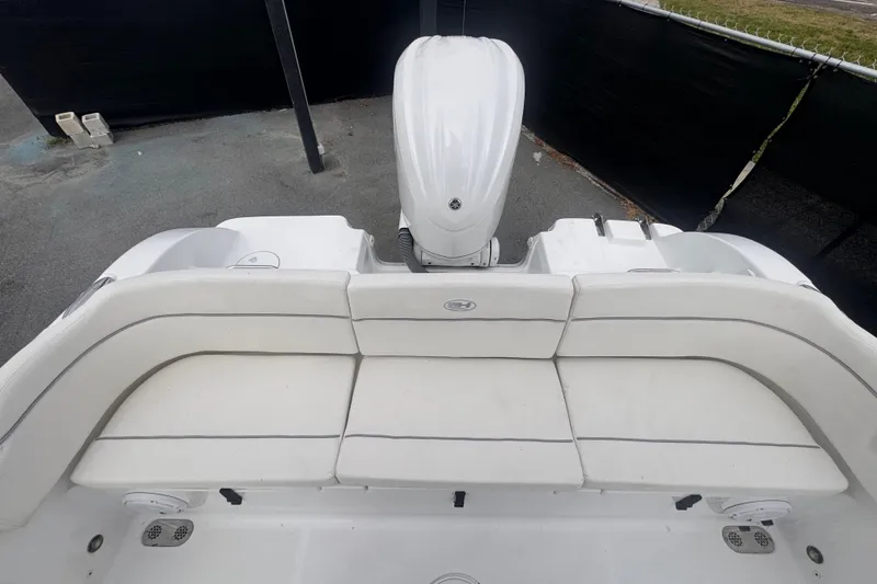 Slide: The Image of 2024 Sea Hunt Escape 25 boat with white seating and outboard motor. - 67