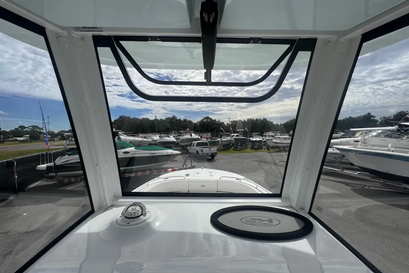 Slide: The Image of 2024 Sea Hunt Escape 25 boat interior view with marina background. - 42