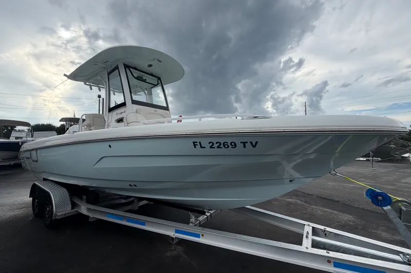 The Image of 2024 Sea Hunt Escape 25 boat on trailer under cloudy sky. - 0