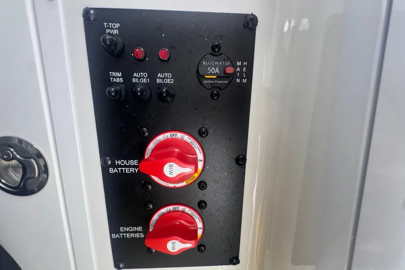 Slide: The Image of Control panel of 2024 Sea Hunt Escape 25 boat with battery switches and power controls. - 47