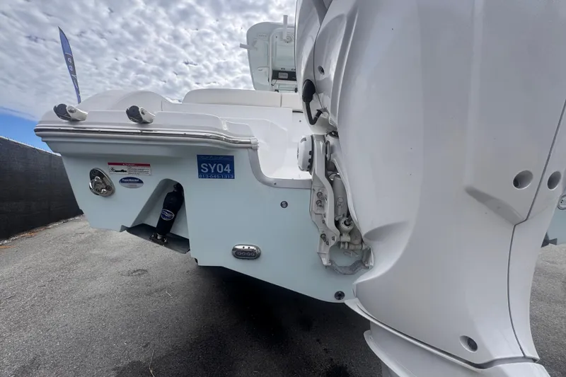 Slide: The Image of 2024 Sea Hunt Escape 25 boat rear view with outboard motor and sleek design. - 6