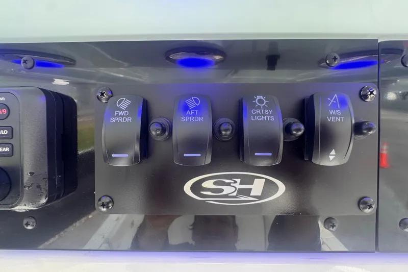 Slide: The Image of Control panel of 2024 Sea Hunt Escape 25 boat with illuminated switches. - 38