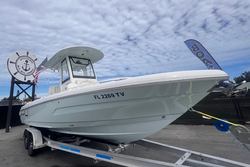 The Image of 2024 Sea Hunt Escape 25 boat on trailer under cloudy sky. - 0