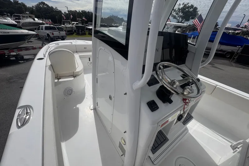 Slide: The Image of 2024 Sea Hunt Escape 25 boat interior with steering console and seating area. - 43