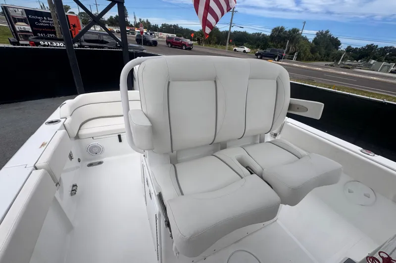 Slide: The Image of 2024 Sea Hunt Escape 25 boat interior with white seating and American flag. - 64