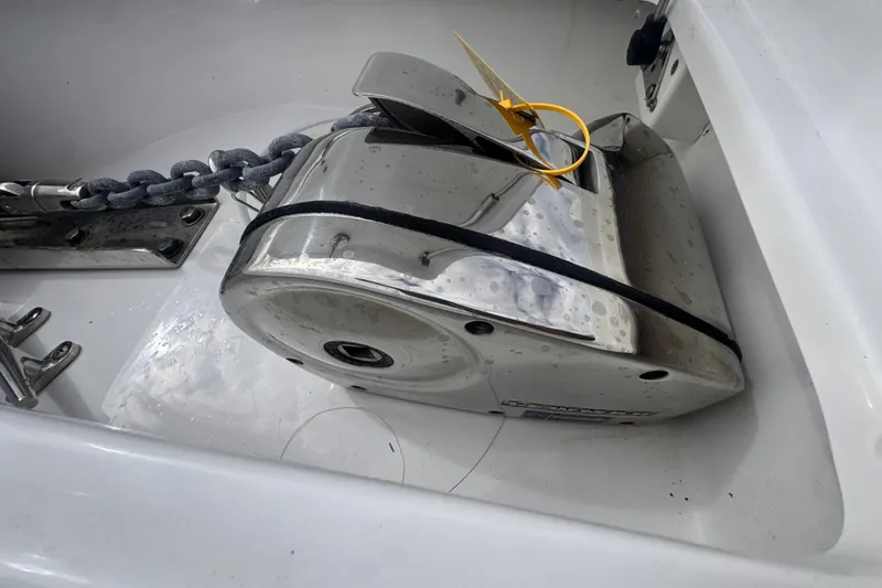 Slide: The Image of 2024 Sea Hunt Escape 25 anchor winch with chain in boat compartment. - 54