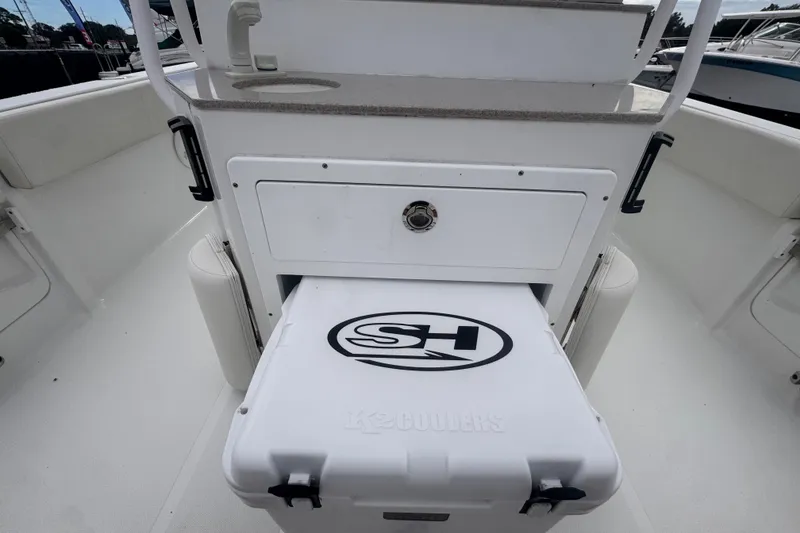 Slide: The Image of 2024 Sea Hunt Escape 25 boat interior with cooler storage and seating area. - 20