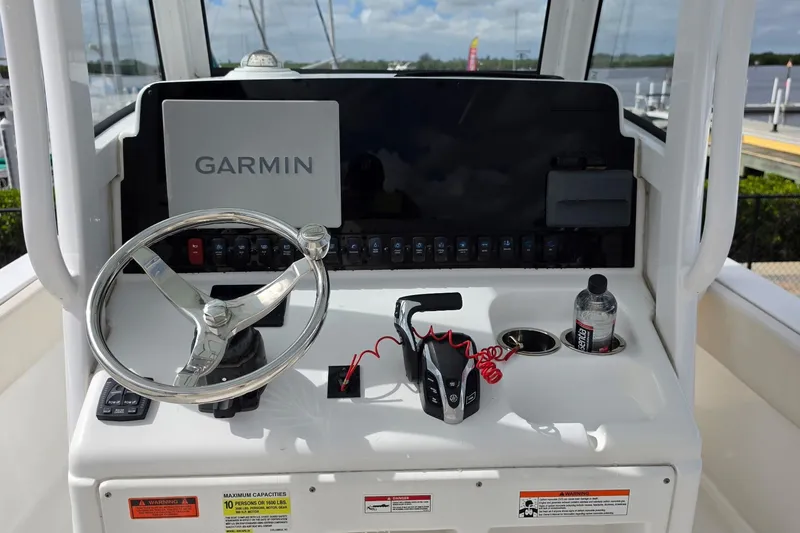 Slide: The Image of 2024 Sea Hunt Escape 25 helm with Garmin display and steering wheel. - 7