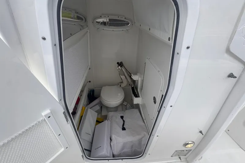 Slide: The Image of 2024 Sea Hunt Escape 25 boat interior with compact marine toilet. - 45