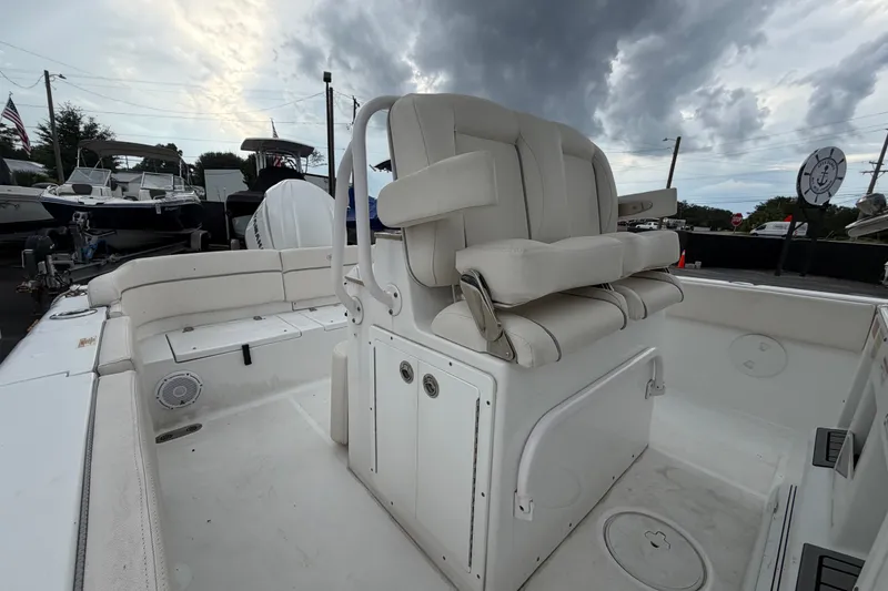Slide: The Image of 2024 Sea Hunt Escape 25 boat interior with cushioned seating and overcast sky. - 8