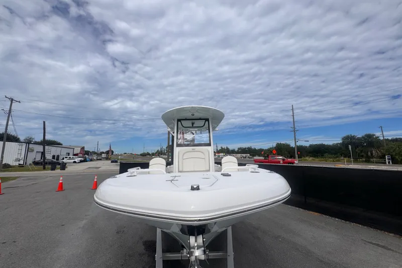 Slide: The Image of 2024 Sea Hunt Escape 25 boat on trailer under cloudy sky. - 12
