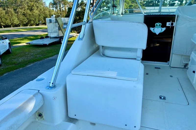 Slide: The Image of 2002 Pursuit 3000 Express boat interior with seating and deck view. - 25