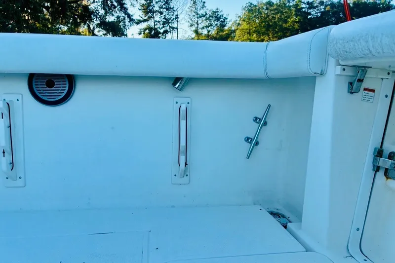 Slide: The Image of 2002 Pursuit 3000 Express boat interior with white seating and deck details. - 78