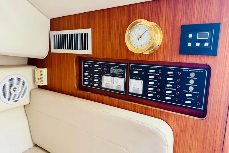 Slide: The Image of Control panel of a 2002 Pursuit 3000 Express boat with gauges and switches. - 14