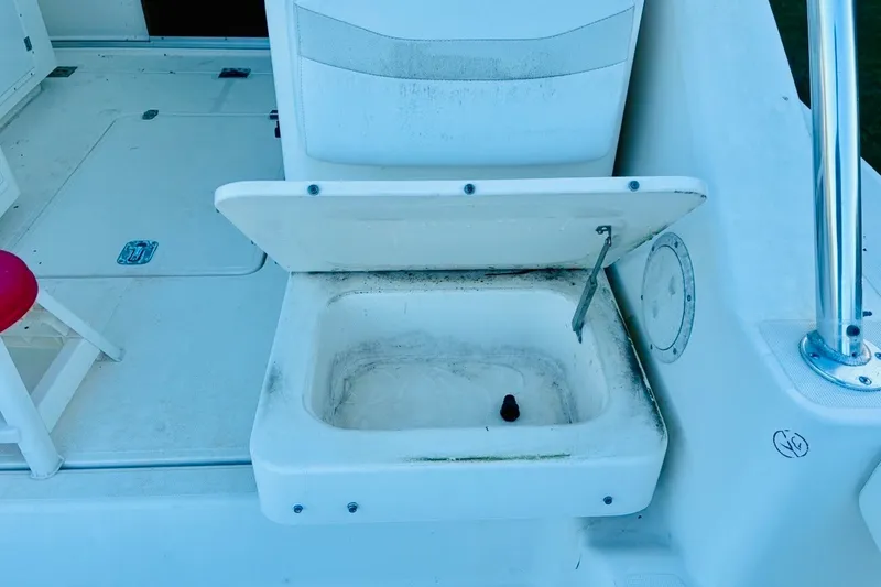 Slide: The Image of Open storage compartment on 2002 Pursuit 3000 Express boat deck. - 62
