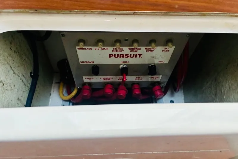 Slide: The Image of Control panel of a 2002 Pursuit 3000 Express boat with labeled switches and wiring. - 51