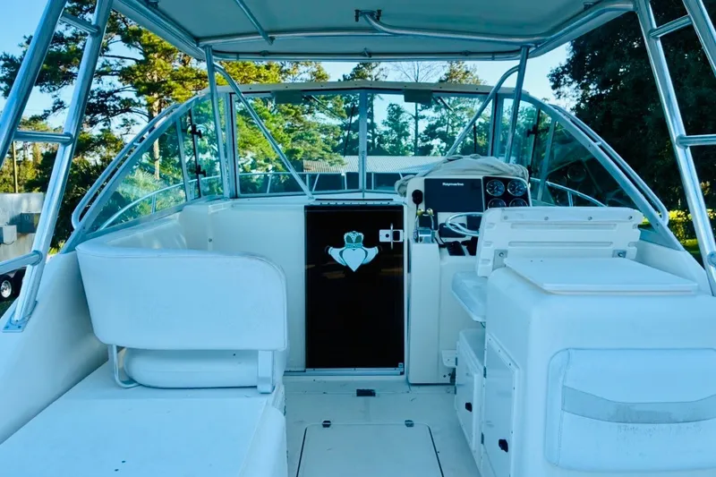 Slide: The Image of 2002 Pursuit 3000 Express boat interior with helm and seating area. - 71