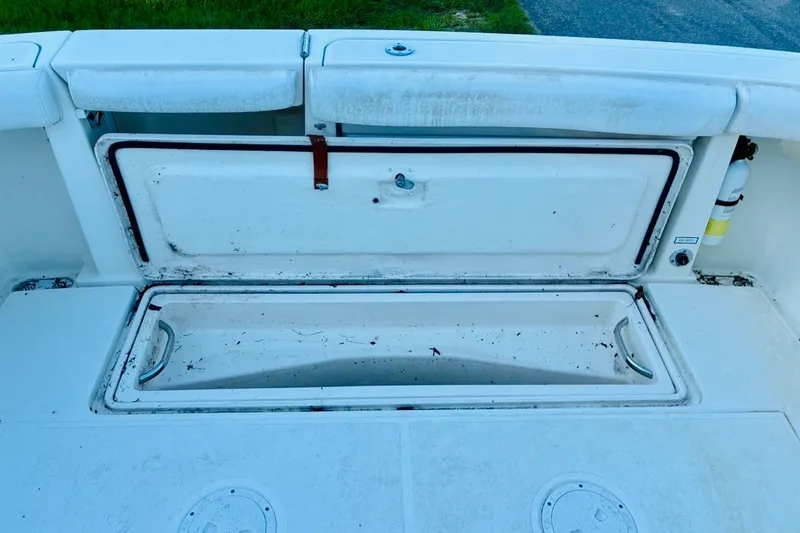 Slide: The Image of Open storage compartment on a 2002 Pursuit 3000 Express boat, showing interior details. - 73