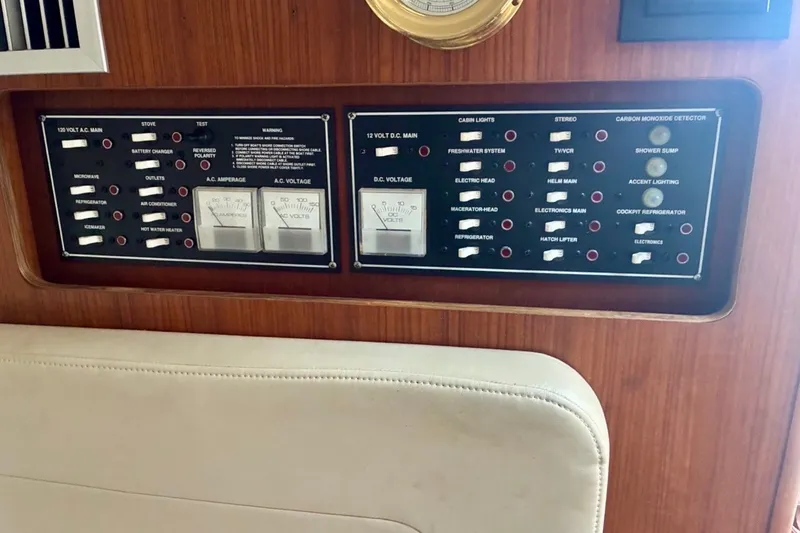 Slide: The Image of Control panel of a 2002 Pursuit 3000 Express boat with various switches and gauges. - 50
