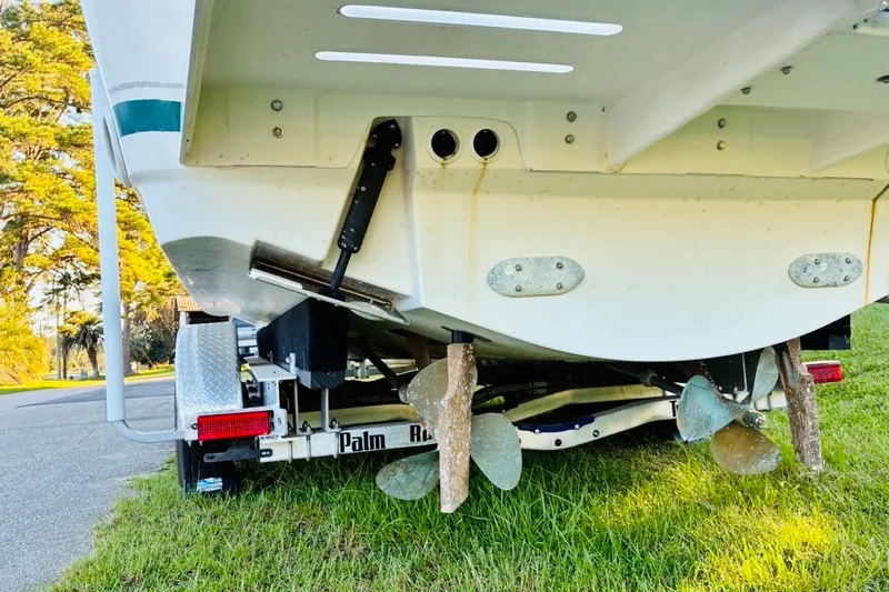 Slide: The Image of 2002 Pursuit 3000 Express boat on trailer, showing propellers and stern details. - 83