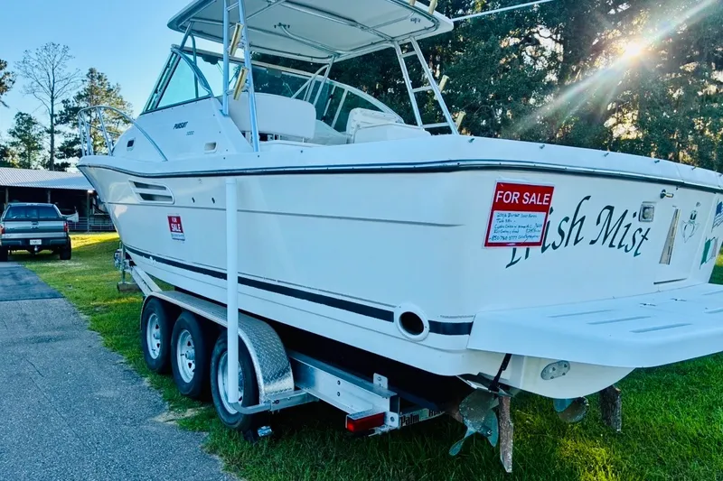 Slide: The Image of 2002 Pursuit 3000 Express boat on trailer, for sale, parked outdoors. - 86