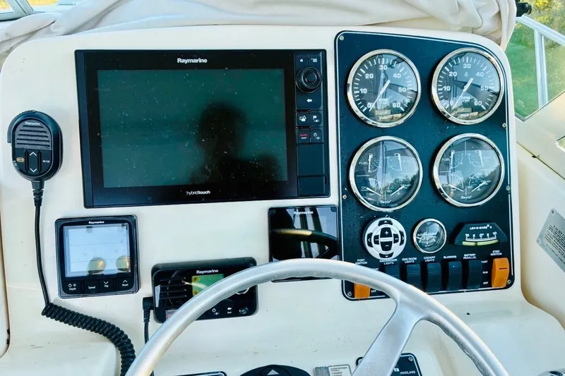 Slide: The Image of Control panel of a 2002 Pursuit 3000 Express boat with Raymarine electronics. - 57