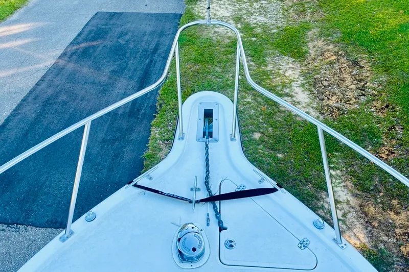 Slide: The Image of Bow view of 2002 Pursuit 3000 Express boat on grass and pavement. - 63