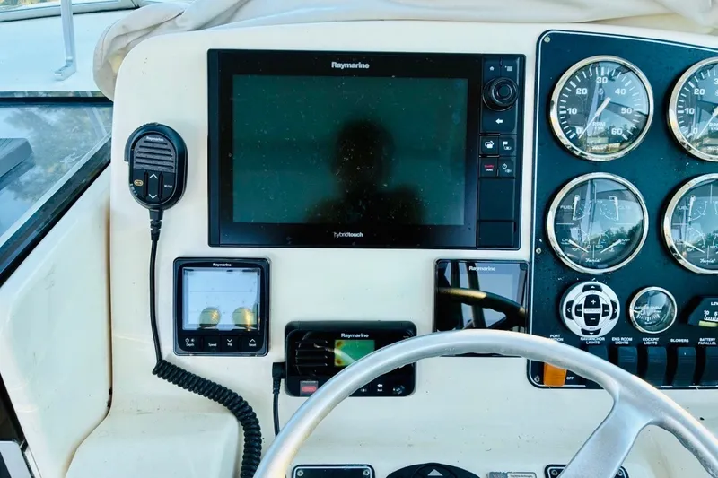 Slide: The Image of Control panel of a 2002 Pursuit 3000 Express boat with navigation instruments. - 56