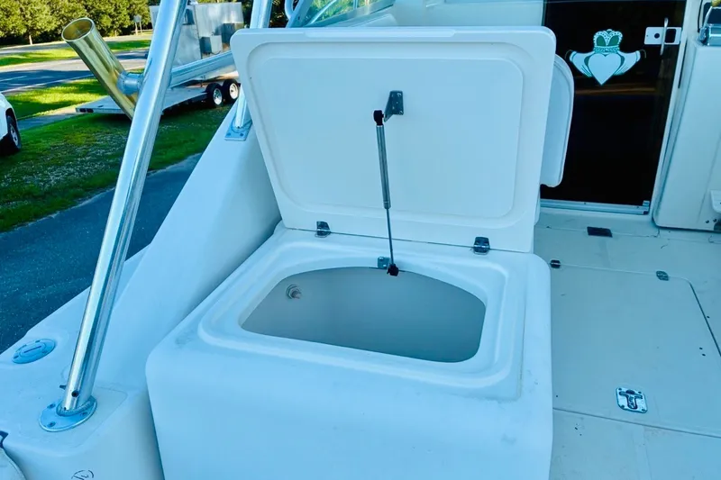 Slide: The Image of Open storage compartment on a 2002 Pursuit 3000 Express boat deck. - 61