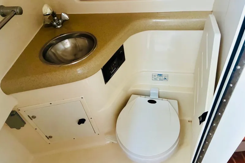 Slide: The Image of 2002 Pursuit 3000 Express boat bathroom with sink and toilet, compact and functional design. - 43