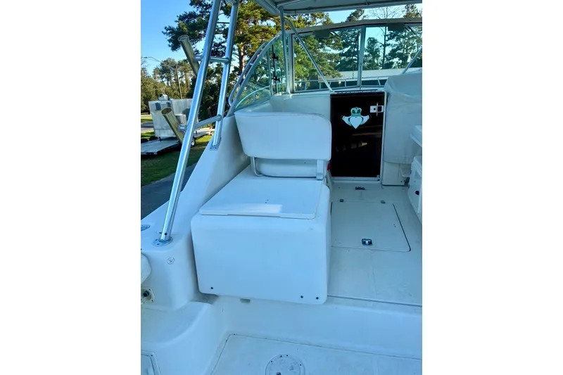 Slide: The Image of 2002 Pursuit 3000 Express boat interior with seating and helm area. - 24