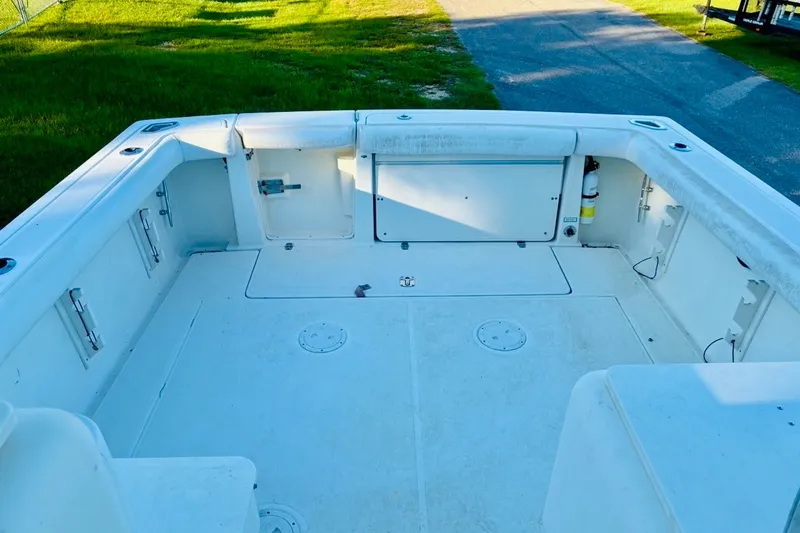 Slide: The Image of 2002 Pursuit 3000 Express boat deck, spacious and clean, with storage compartments. - 21