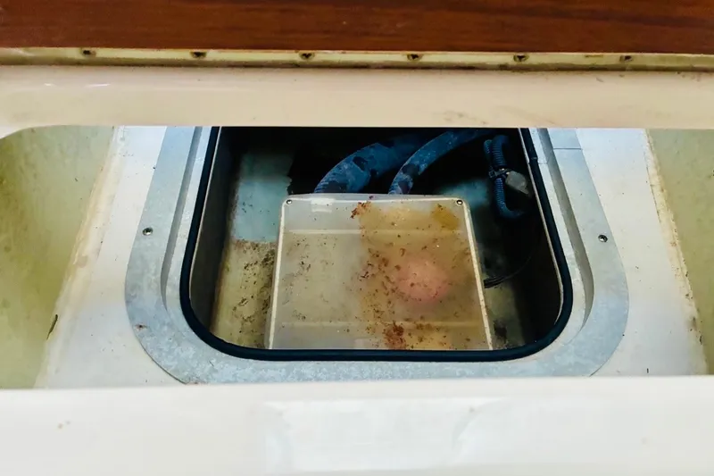 Slide: The Image of Open hatch of a 2002 Pursuit 3000 Express boat showing interior compartment. - 54