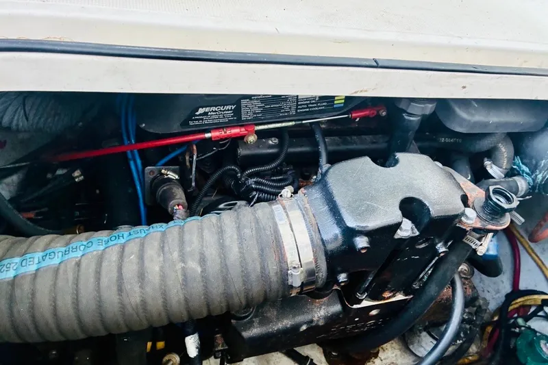 Slide: The Image of Engine compartment of a 2002 Pursuit 3000 Express boat, featuring Mercury components. - 34