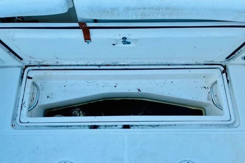 Slide: The Image of Open storage compartment on a 2002 Pursuit 3000 Express boat. - 74