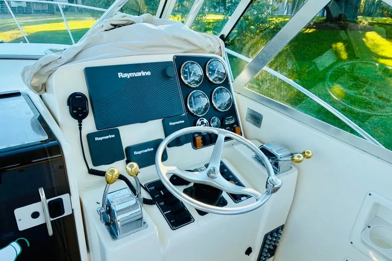 Slide: The Image of Helm of 2002 Pursuit 3000 Express boat with Raymarine electronics and gauges. - 55