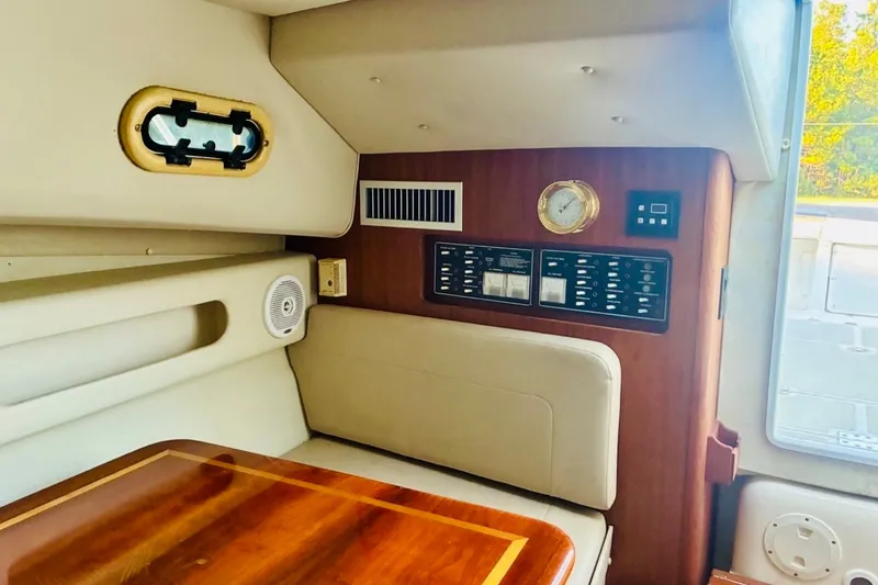 Slide: The Image of Interior of 2002 Pursuit 3000 Express boat with control panel and seating area. - 41